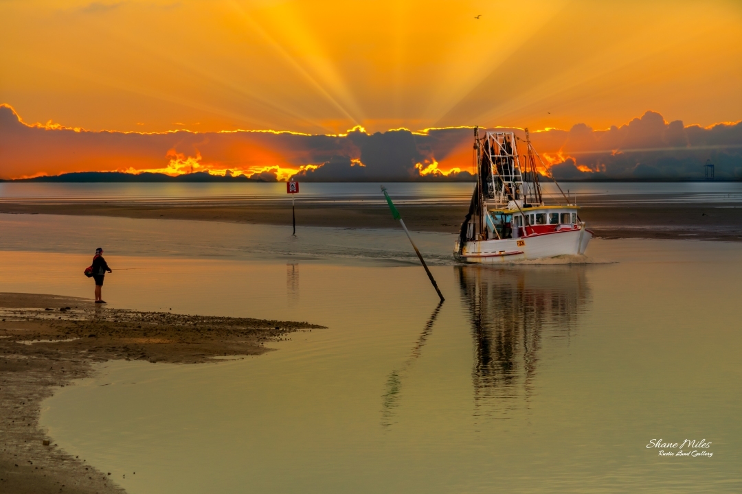 Trawler returning from a long nights fishing. Cabbage Tree Creek, Queensland Australia.